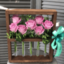 Композиция в рамке с колбами из роз