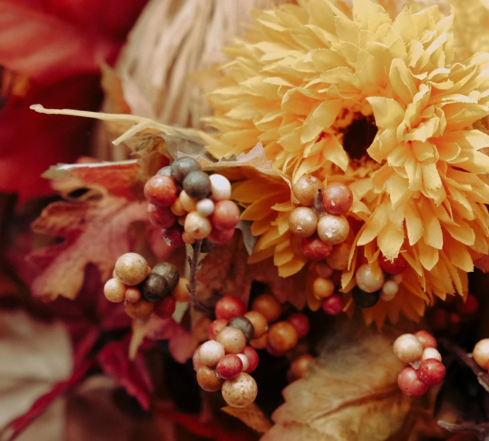 Halloween flower arrangement in hollowed pumpkin with purple and orange blooms